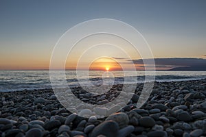 Pebble beach at beautiful sunset.