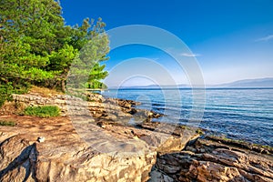 Pebble beach on Brac island with turquoise clear ocean water, Supetar, Brac, Croatia