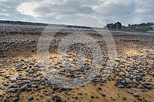 Pebble beach and a castle of Dieppe in Normandy