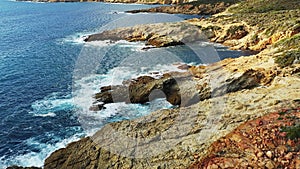 The pebble beach of the Fango Delta and the steep rocks