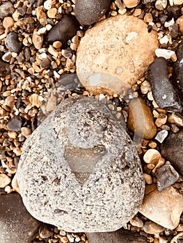 A pebble on a beach with a Love heart