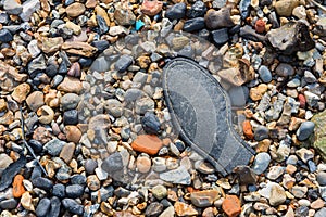 Pebble beach with a part of an old shoe