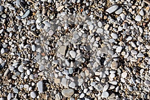 pebble beach of stones and yellow sand