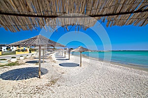 Pebble beach and umbrellas view, Island of Vir