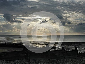 Pebble Beach at Whitstable with jacobs ladder sunlight photo