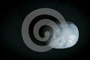 Pebble polished larimar tumbled stone on a black background