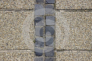 Pebble shingle cobblestone sidewalk background or texture.