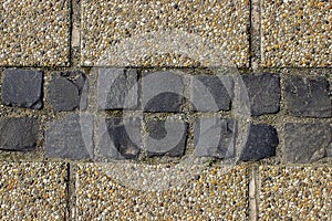 Pebble shingle cobblestone sidewalk background or texture.