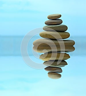 Pebble stack reflecting in the water