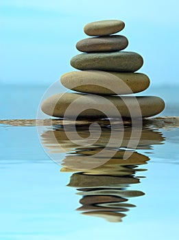 Pebble stack reflecting in the water