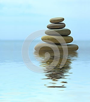 Pebble stack reflecting in the water