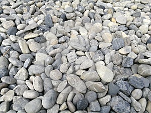 Pebble stone background, outdoor natural river white grey rock pebble small size, abstract dry garden round stones texture backgro