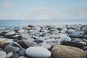 Pebble stone beach ocean and blue sky