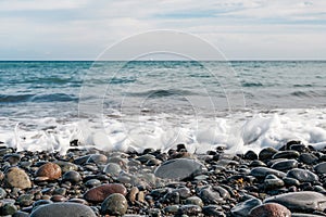 Pebble stone beach - stones at ocean coast