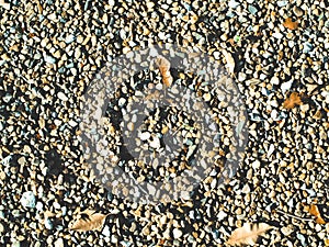 Pebble or stone and rock dried fallen leaves ground on sand beach or river summer holiday background