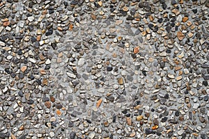 Pebble stones in a concrete wall texture