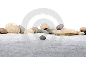 Pebble stones on gray sand