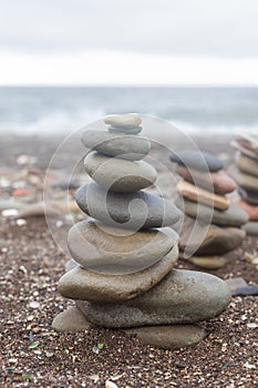 Pebble tower balance harmony stones arrangement on sea beach