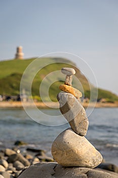 Pebble tower at beach symbolising stability, zen, harmony, balance