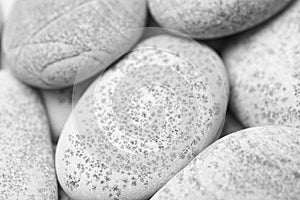 Pebbles background, abstract background with dry round gray reeble stones, gray close-up pebbles background, spa relaxation concep