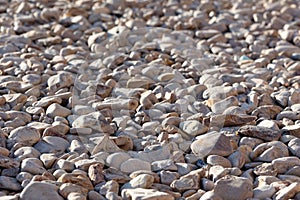 Pebbles background. Round stones. Beach shore