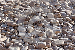 Pebbles background. Round stones. Beach shore