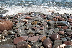 Pebbles on the Beach Being Washed by Wave