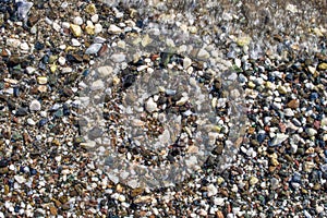 Pebbles and Foam. stones and sea. Pebbles stones texture