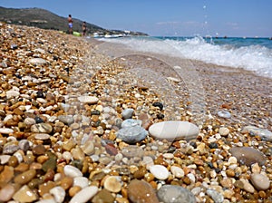 Pebbles mixed with sand of the beautiful Skala beach, Kefalonia island, Ionian sea, Greece