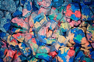 Pebbles painted colored paints in bright