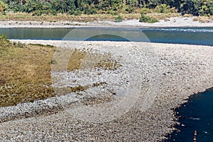 Pebbles and River flow in Manas National Park, Assam, India photo
