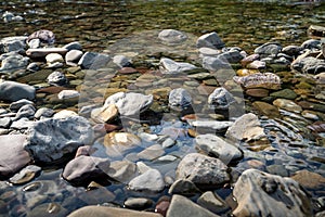 Pebbles and rocks in Avalanche Creek in Glacier National Park Montana. Selective focus