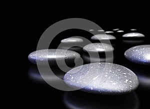 Pebbles in a row over black background