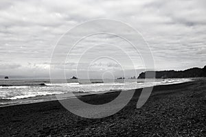 Pebbles on a sandy beach, shiny wet stones and waves