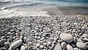 Pebbles on the shore of the sea. Gray smooth stones on the beach