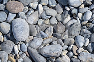 Pebbles and stones rounded by the sea, abstract background composition