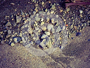 Pebblestones at the dirt road background