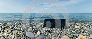 Pebbly and rocky beach. smartphone. freelance coastline of the sea