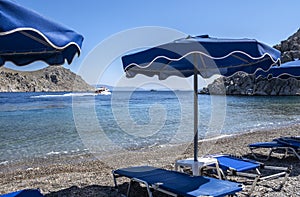 Pebbly St. Nicholas Beach on Symi Greece with a View of Crystal Clear Water and Distant Mountains