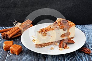 Pecan caramel cheesecake with a dark background