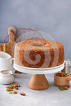 Pecan caramel pound cake baked in a bundt pan served on a cake stand