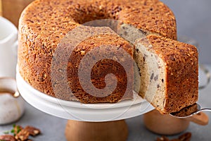 Pecan caramel pound cake baked in a bundt pan served on a cake stand