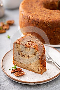 Pecan caramel pound cake baked in a bundt pan slice on a plate