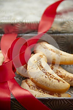 Pecan lady finger holiday cookies with a red bow and ribbon