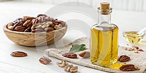 Pecan nut oil bottle isolated on white