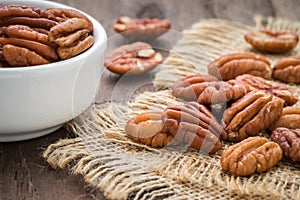 Pecan nuts on sackcloth and bowl