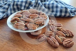 Pecan Nuts in a white bowl with a blue and white teatowel