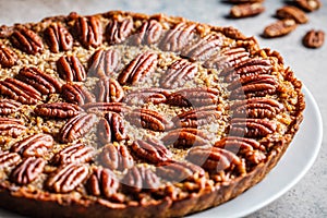 Pecan Pie on gray-brown background. Vegan dessert concept