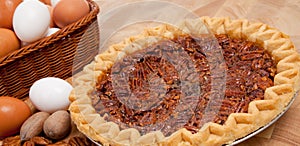 Pecan pie with ingredients on a cutting board