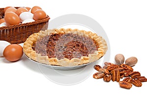 Pecan pie with ingredients on a white background